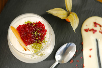 Delicious dessert cold cream with a pomegranate on a tables