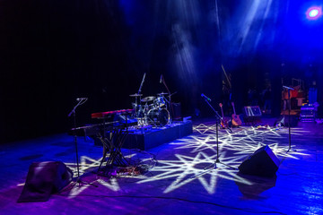 Stage lights. Several projectors in the dark. Multi-colored light beams from the stage spotlights...