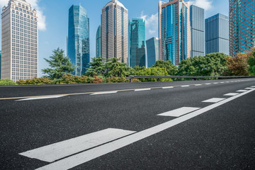Empty asphalt road along modern commercial buildings in China's cities