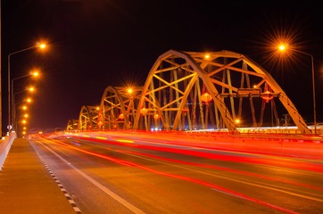 Fototapeta na wymiar Bridge in the evening with midnight blue sky and blurred tail lights