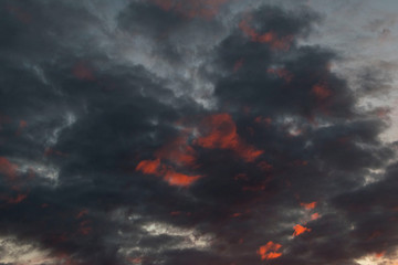 red bloody sunset in cloudy sky above the village. beautiful countryside landscape