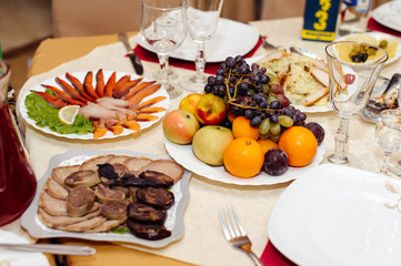 Buffet table of reception with cold snacks, meat, salads and fruits