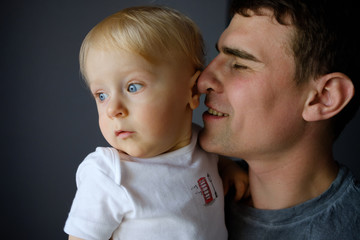 Dad holds the baby in his arms. Embrace of the father and child. Father's day holiday