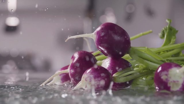 Falling of radish into the wet table. Slow motion 240 fps