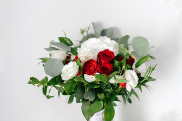 Obraz na płótnie Canvas Wedding bouquet of white and red roses on a white background
