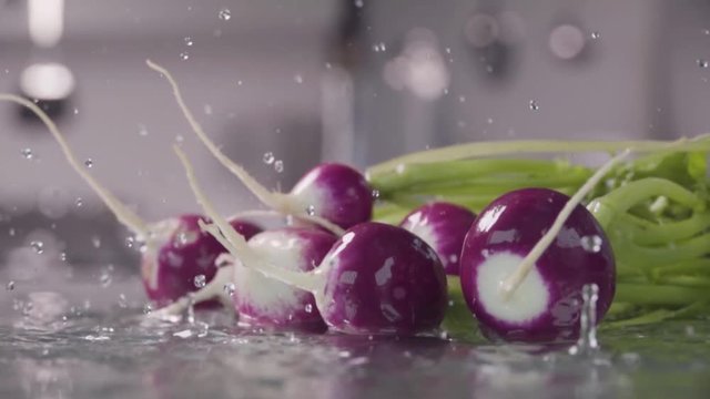 Falling of radish into the wet table. Slow motion 480 fps