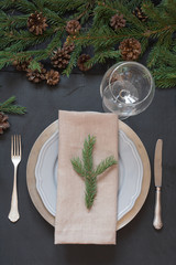 Christmas table setting with silverware and dark evergreen decor. Top view. Holiday Centerpieces.
