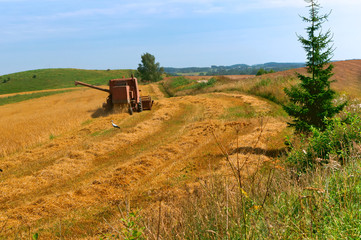 Grain harvesters. In the field working farm machinery. Agricultural land. Spring plowing.