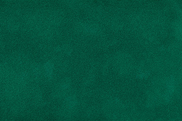 Dark green matt suede fabric closeup. Velvet texture.
