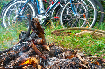 Bicycle ride. Biking in the wilderness. Cycling in the suburbs. Traveling by bicycle. Campfire on a camping trip.