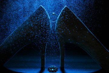 Engagement ring on a black background with the effect of small splashes of water