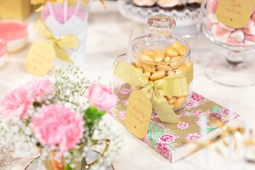 Gold almonds in icing on a glamour candy bar at the wedding party