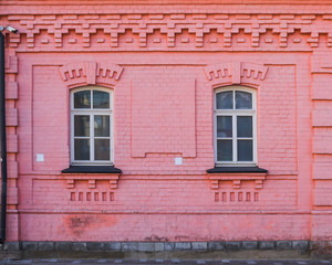 Fototapeta na wymiar Vintage architecture classical facade red brick building with two windows. Front view close up.