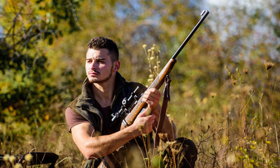 Man hunting wait for animal. Hunter with rifle ready to hunting nature background. Hunting strategy or method for locating targeting and killing targeted animal. Hunting skills and strategy