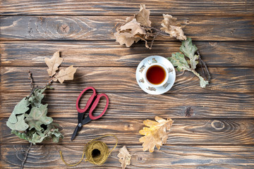 cup of tea and leafs on wooden table