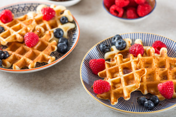 Traditional homemade belgian waffles with fresh berries and syru