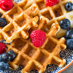 Traditional homemade belgian waffles with fresh berries and syru