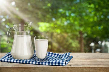 Glass of milk and bottle on  background