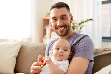 family, parenthood and people concept - happy father with little baby daughter at home