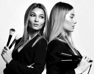 Two young beautiful european makeup artists friends or girlfriends women in dresses