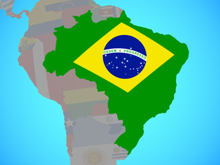 Brazil with national flag on blue political globe.