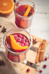 Glass cups of Christmas mulled red wine with spices and fruits