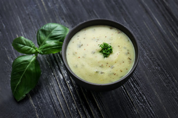 Tasty sauce in bowl on wooden table