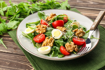 Delicious fresh salad with walnuts on plate