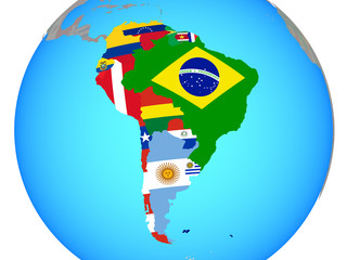 South America with national flags on blue political globe.