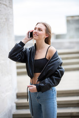 Fototapeta premium Teenage girl talking on mobile phone happy