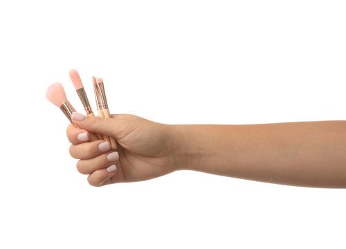 Woman Holding Makeup Brushes On White Background