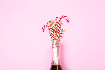 Festive composition with champagne & golden glitter. Traditional New Year celebration. Winter holiday season, christmas time concept. Greeting card mock up. Background, top view, copy space, flat lay