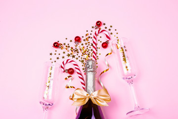 Festive composition with champagne & golden glitter. Traditional New Year celebration. Winter holiday season, christmas time concept. Greeting card mock up. Background, top view, copy space, flat lay