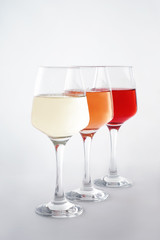 Glasses of tasty wine on white background