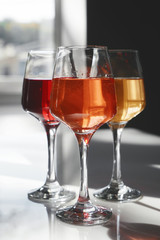 Glasses of tasty wine on table