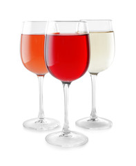 Glasses of different wine on white background