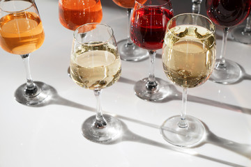 Glasses of different wine on table