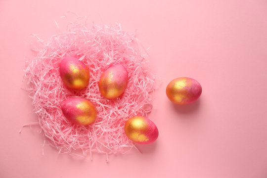 Nest with Easter eggs on color background