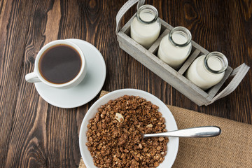 Fototapeta na wymiar Coffee with milk and muesli granula, breakfast time.
