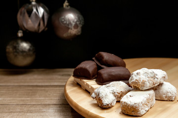 typical Spanish almond, almond and chocolate polvorón on black