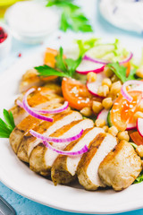 Grilled chicken with fresh vegetables olive oil dressing. Selective focus, Space for text.