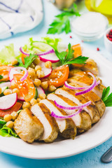 Grilled chicken with fresh vegetables olive oil dressing. Selective focus, Space for text.