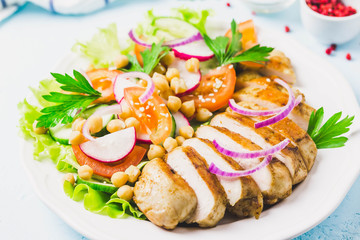 Grilled chicken with fresh vegetables olive oil dressing. Selective focus, Space for text.