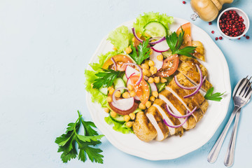 Grilled chicken with fresh vegetables olive oil dressing. Selective focus, Space for text.
