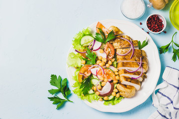 Grilled chicken with fresh vegetables olive oil dressing. Selective focus, Space for text.