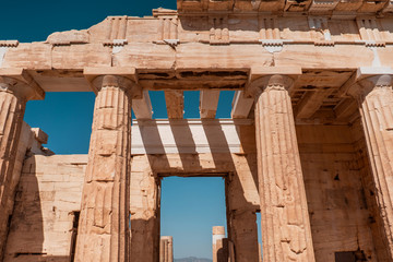 Aisle in an ancient building with columns in Acropolis of Athens.