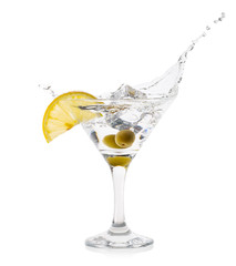 Martini splash with lemon ice cube and green olives in cocktail 