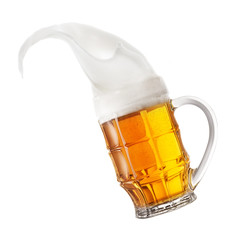 Mug of light beer with splashing foam