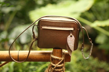 stylish women's bag on a tropical background