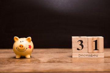 Calendar date for End of Financial Year, 31 december with piggy bank on dark background